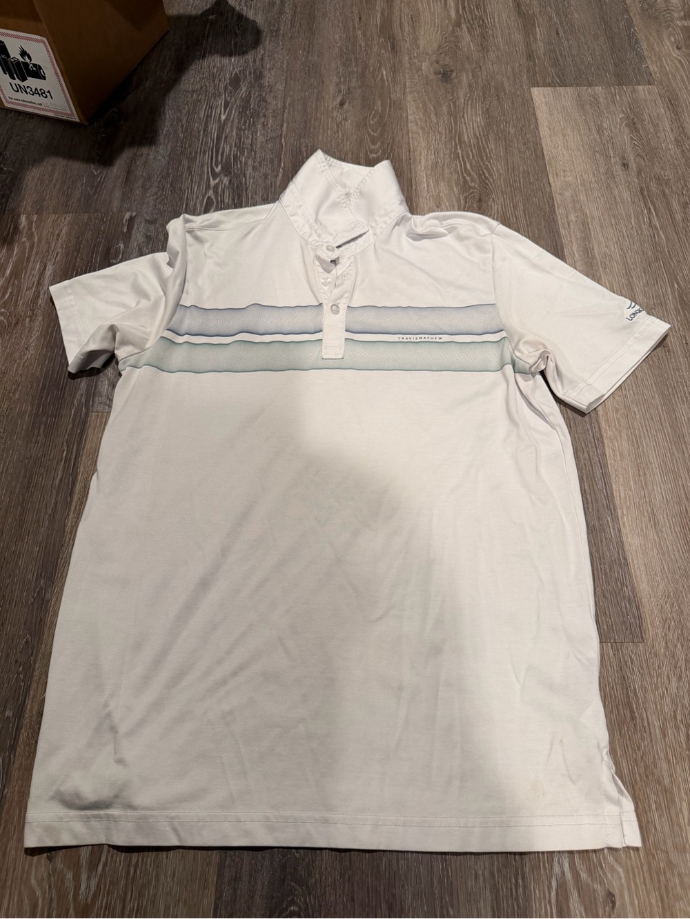 Travis Mathew White Polo with Light Blue and Gray Chest Stripes